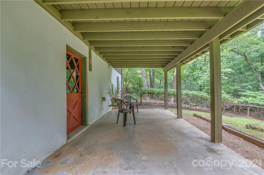 355 Winterset Trail Tryon, NC 28782 - Photo 20 of 22 a view of a porch with chairs and backyard