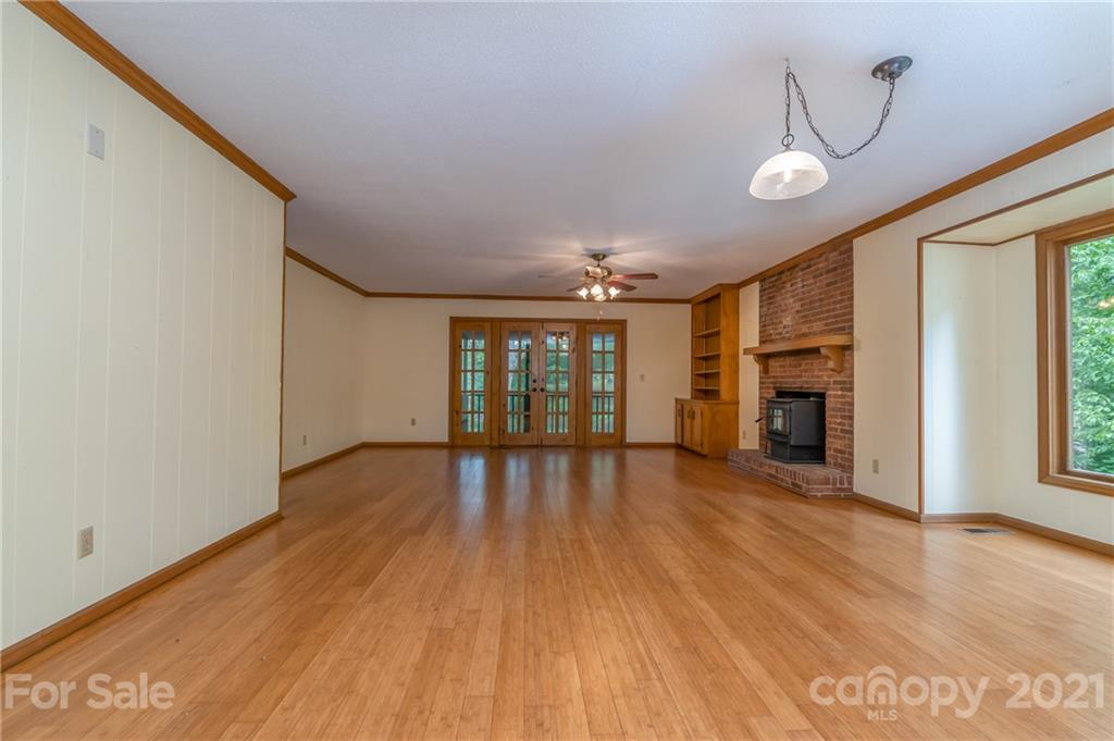355 Winterset Trail Tryon, NC 28782 - Photo 7 of 22 a view of an empty room with wooden floor and a window
