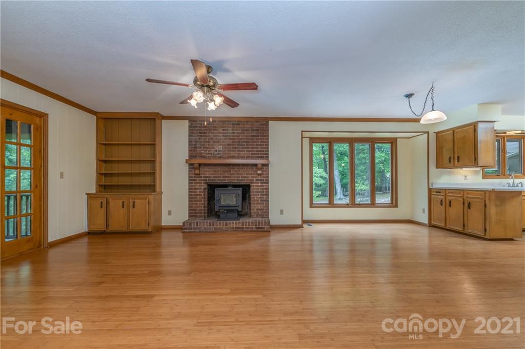 355 Winterset Trail Tryon, NC 28782 - Photo 8 of 22 a view of an empty room with a window and a kitchen