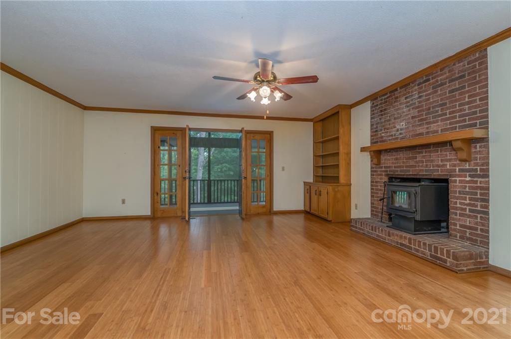 355 Winterset Trail Tryon, NC 28782 - Photo 9 of 22 a view of an empty room with a fireplace and a window