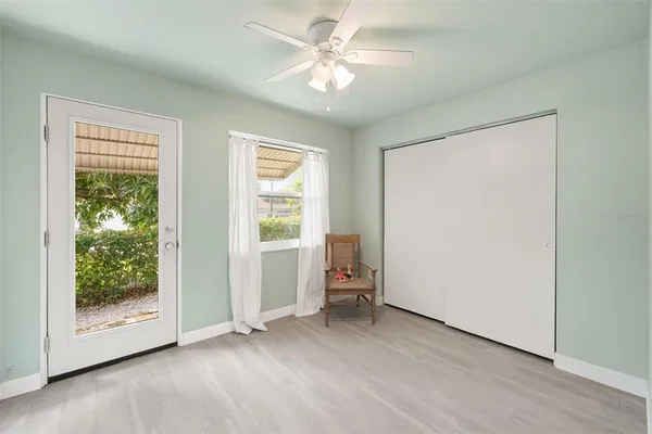 an empty room with windows and closet