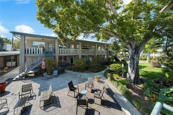 a view of a house with backyard sitting area and garden