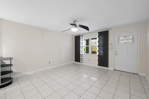 a view of an empty room with window and cabinet