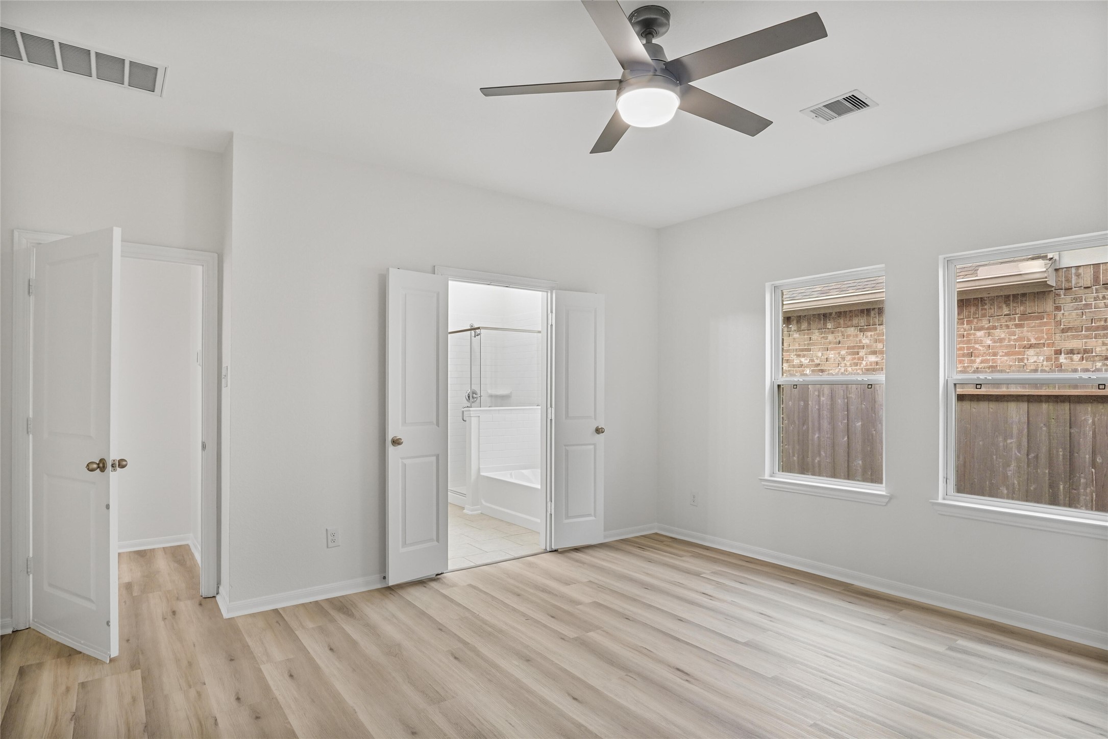 10511 Kings River Drive Rosharon, TX 77583 - Photo 11 of 25 a view of an empty room with a window and wooden floor