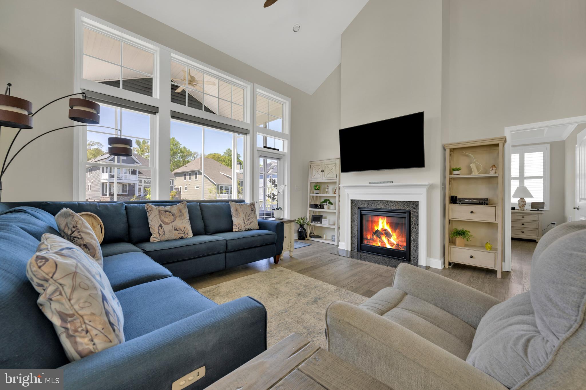 11886 Haslet Road Lewes, DE 19958 - Photo 11 of 60 a living room with furniture a flat screen tv and a fireplace