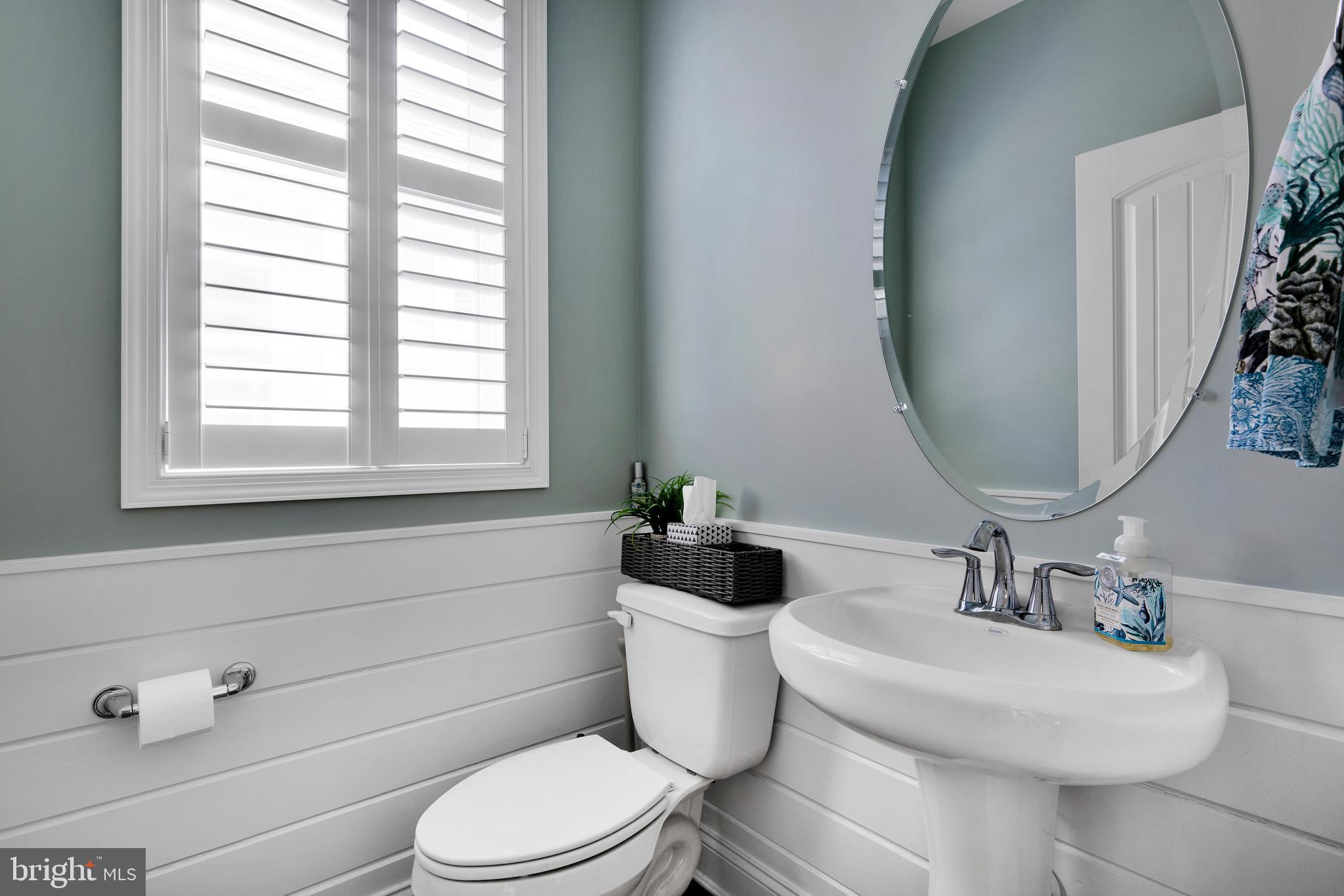 11886 Haslet Road Lewes, DE 19958 - Photo 20 of 60 a bathroom with a toilet a sink and a window