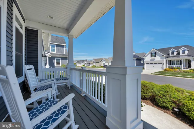 a front view of a house with a yard fire pit and outdoor seating
