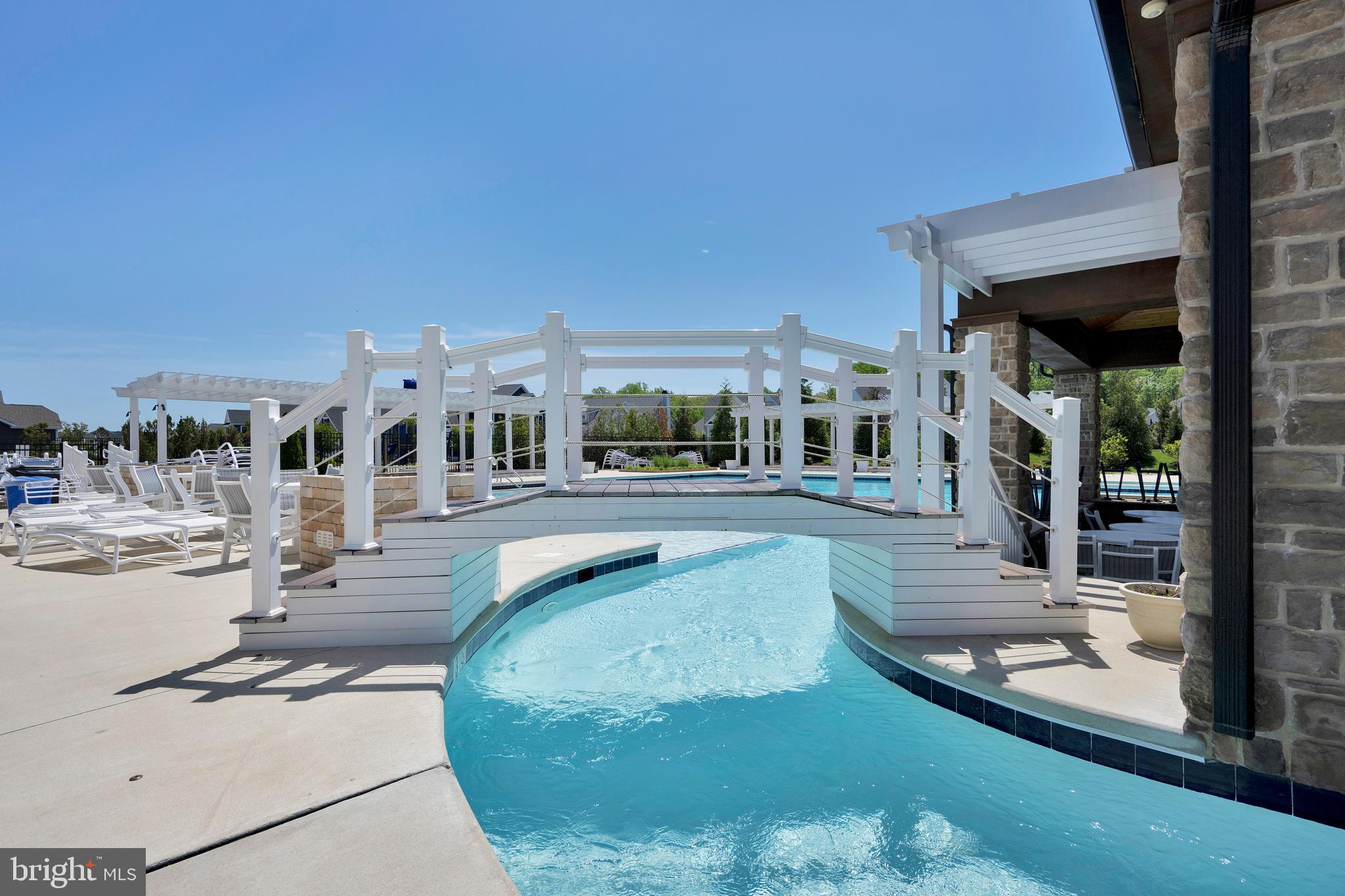 11886 Haslet Road Lewes, DE 19958 - Photo 45 of 60 a view of a swimming pool with outdoor seating