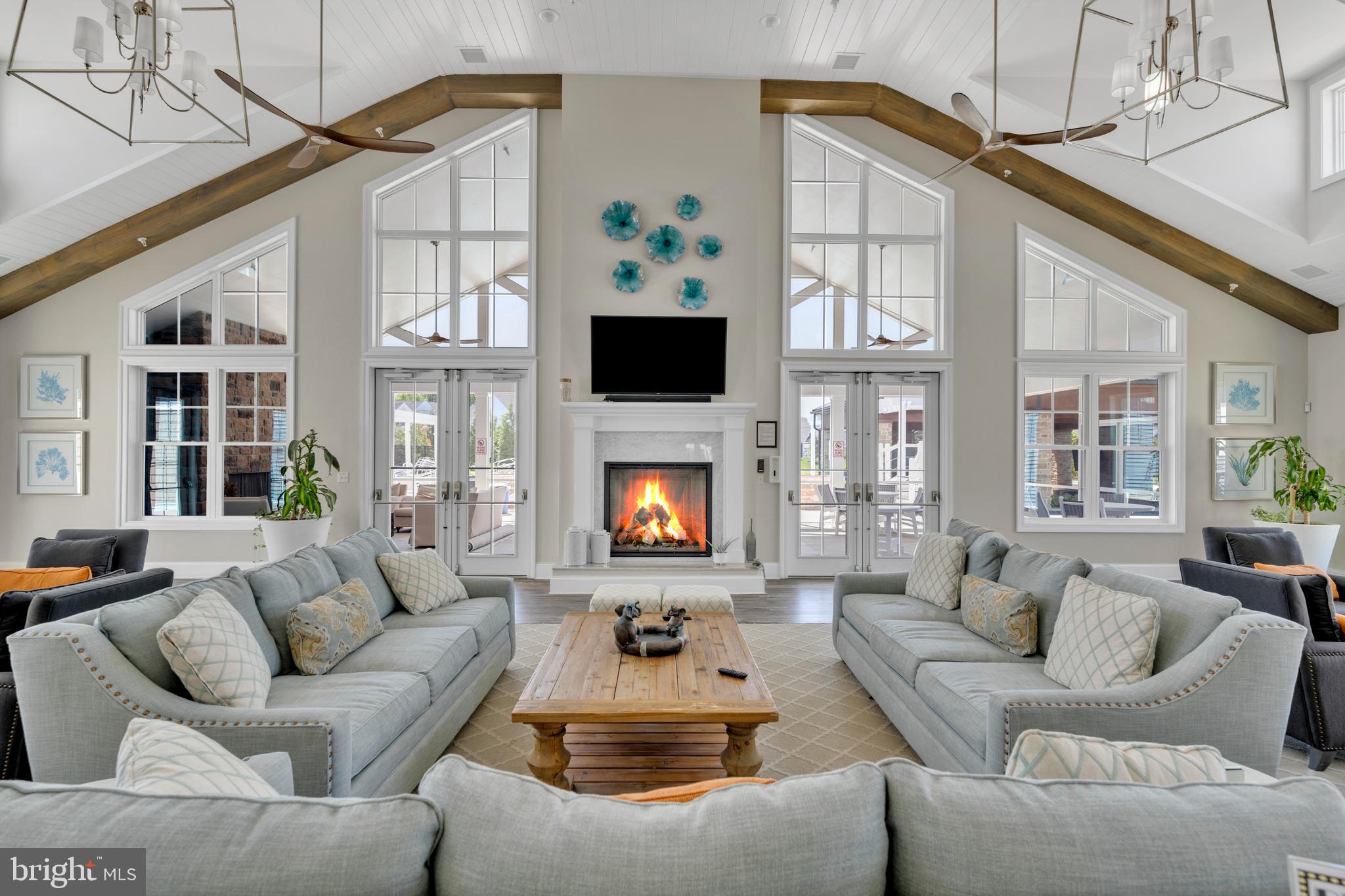 11886 Haslet Road Lewes, DE 19958 - Photo 49 of 60 a living room with furniture a flat screen tv and a fireplace