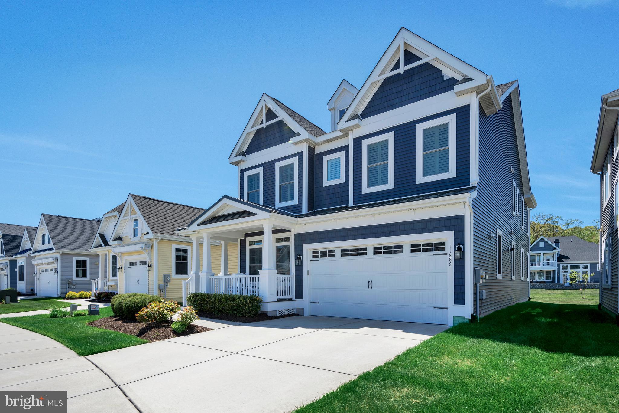 11886 Haslet Road Lewes, DE 19958 - Photo 5 of 60 a front view of a house with a garden and yard