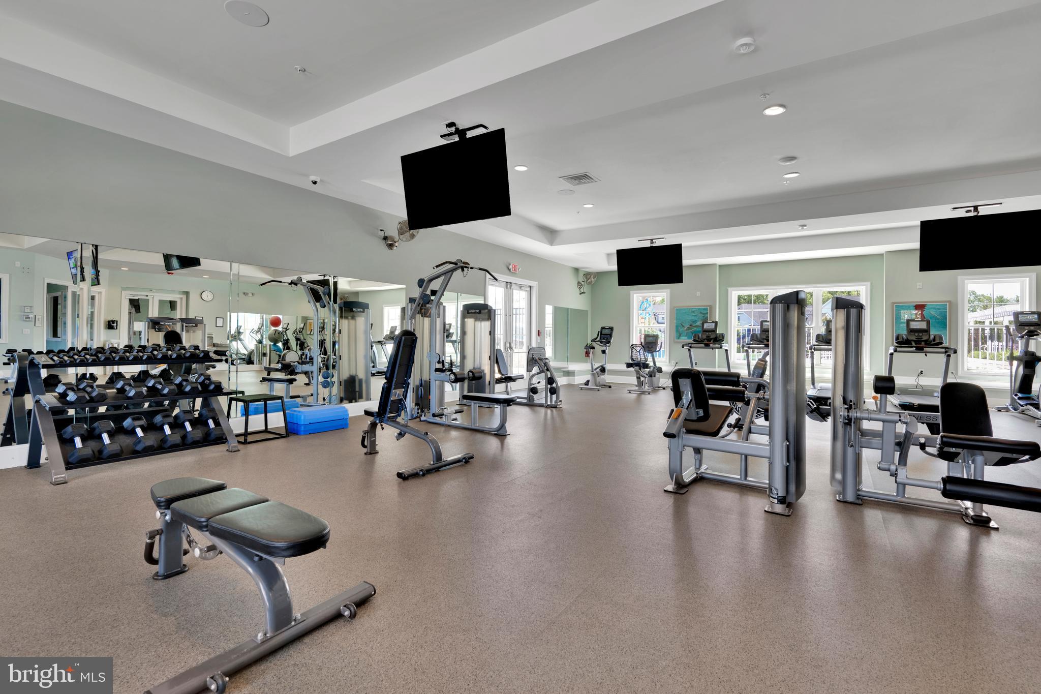 11886 Haslet Road Lewes, DE 19958 - Photo 58 of 60 a gym room with lots of furniture and a flat screen tv