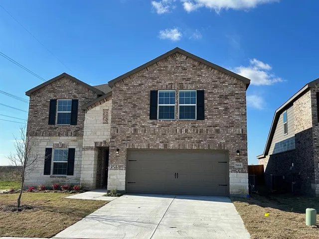 a front view of a house with yard