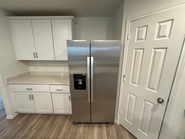 a kitchen with cabinets and stainless steel appliances