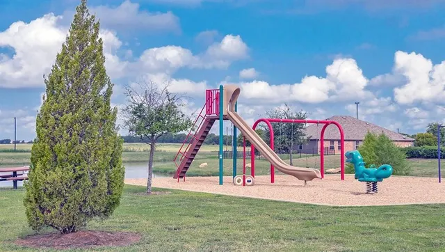 a view of a house with a yard and potted plants