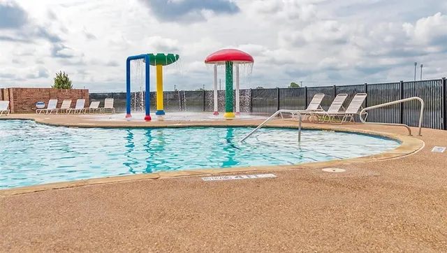 a view of a swimming pool with a lounge chairs