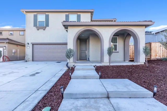 a front view of a house with a yard