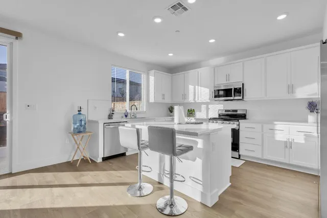 a kitchen with stainless steel appliances white cabinets and a stove