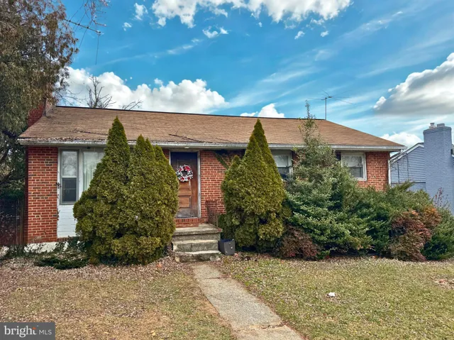 front view of a house with potted plants