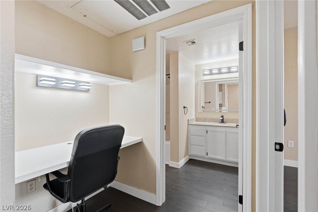 10550 West Alexander Road, Unit 2177 Las Vegas, NV 89129 - Photo 6 of 19 This dedicated workspace provides a functional and comfortable area for productivity, complemented by an adjoining bathroom.