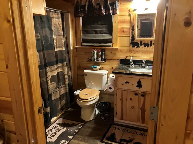 a bathroom with a toilet and a shower