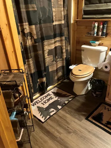 a bathroom with a toilet and a shower