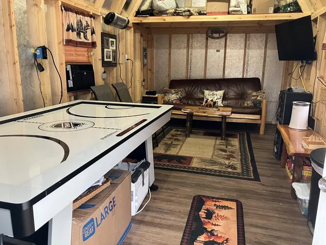 a kitchen with a sink appliances and wooden floor