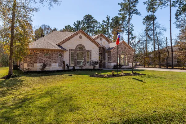 a view of swimming pool with lawn chairs and plants