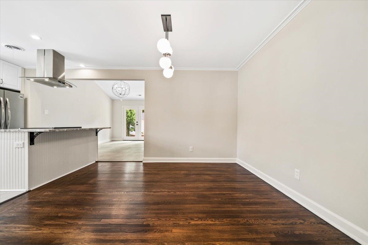 170 South Greer Street Memphis, TN 38111 - Photo 18 of 35 Dining area featuring dark wood-finish flooring, light neutral wall paint, and white crown molding