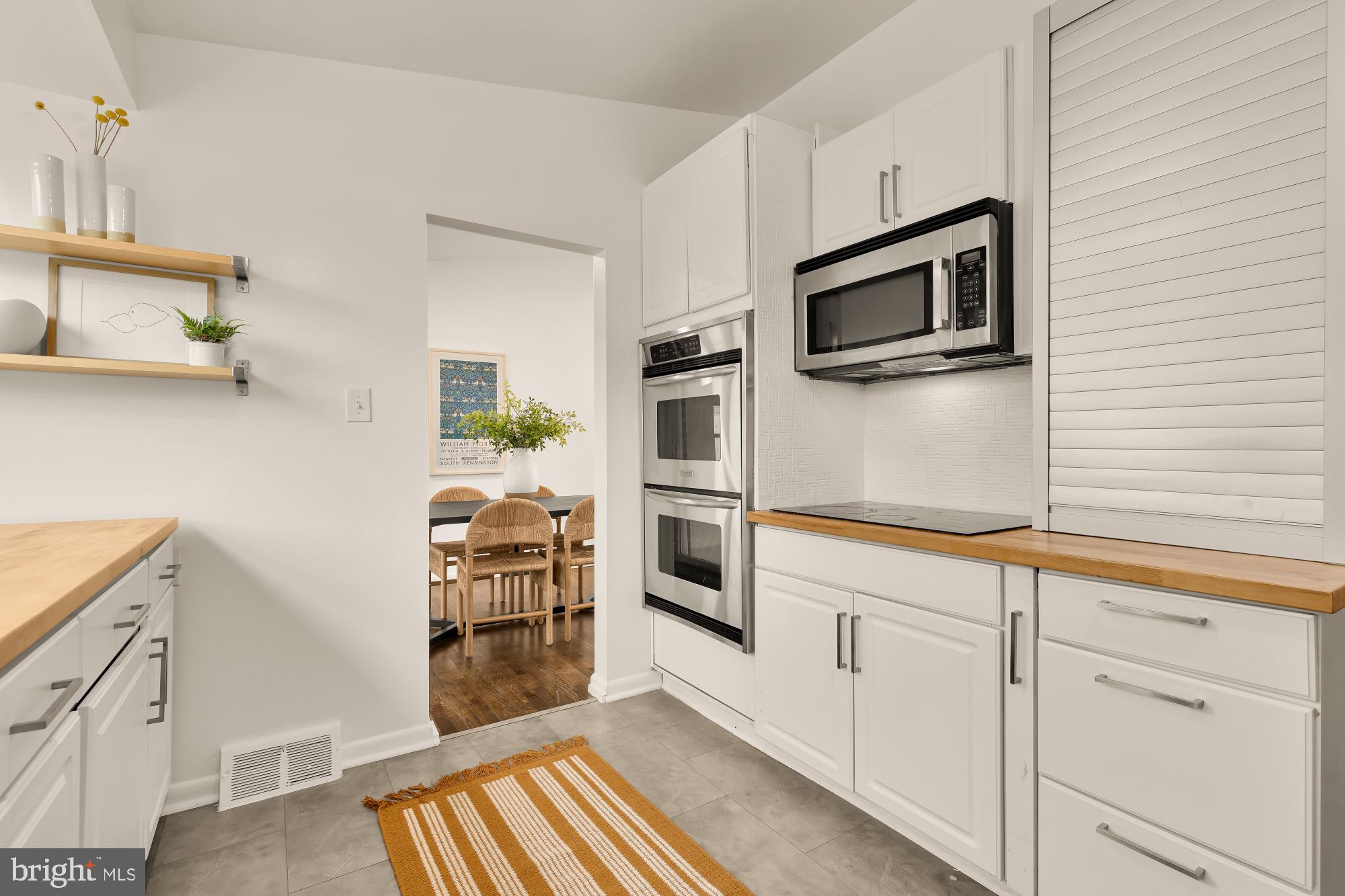 405 Irwin Street Silver Spring, MD 20901 - Photo 15 of 39 a kitchen with white cabinets and microwave