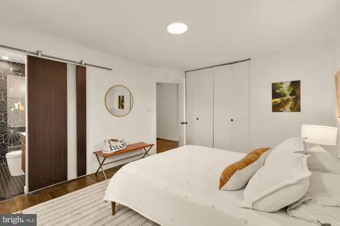 a bedroom with a bed and a lamp