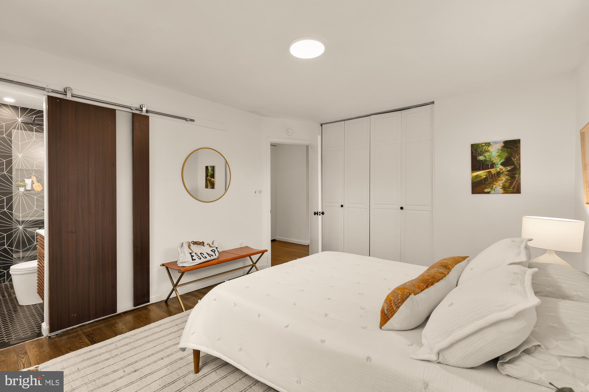 405 Irwin Street Silver Spring, MD 20901 - Photo 23 of 39 a bedroom with a bed and a lamp