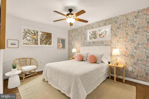 a bedroom with a bed and a painting on the wall