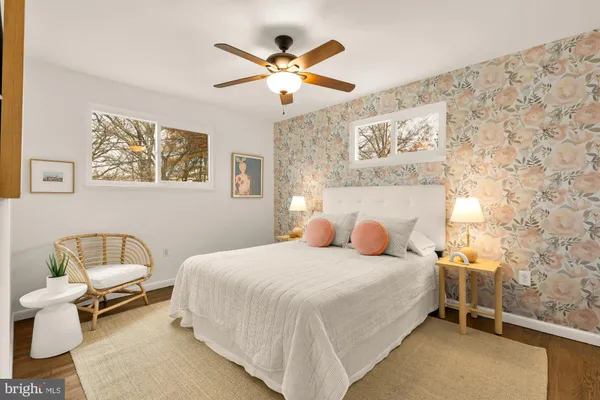 a bedroom with a bed and a painting on the wall