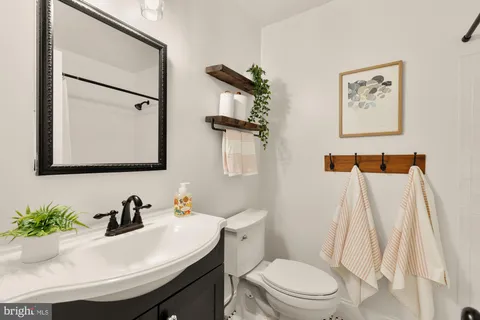 a bathroom with a sink toilet and mirror