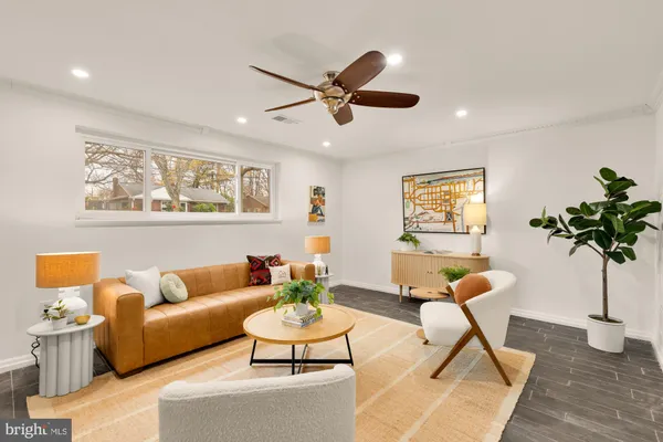 a living room with furniture and a potted plant