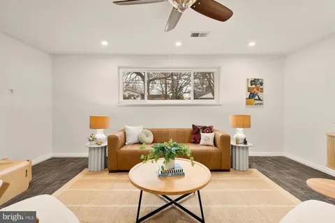 a living room with furniture and a rug