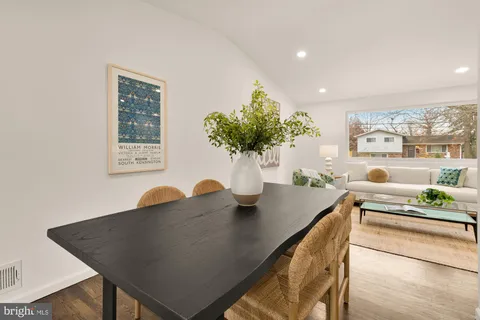 a view of a dining room with furniture and a potted plant