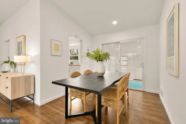 a view of a dining room with furniture and wooden floor