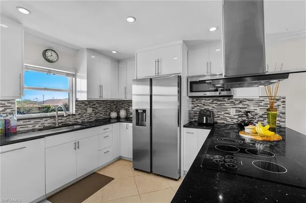 a kitchen with stainless steel appliances granite countertop a sink and cabinets