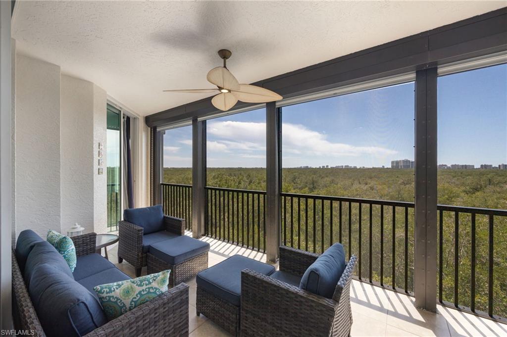 425 Cove Tower Drive, Unit 502 Naples, FL 34110 - Photo 16 of 18 a living room with furniture and a large window