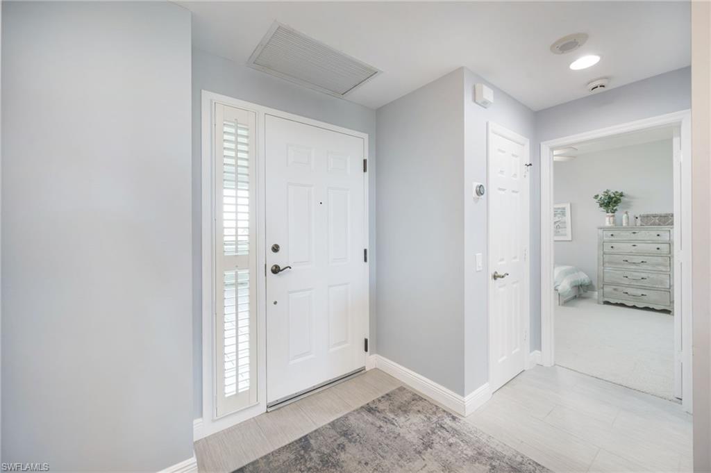 425 Cove Tower Drive, Unit 502 Naples, FL 34110 - Photo 2 of 18 a view of livingroom with kitchen