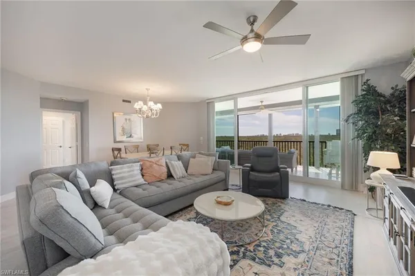 a living room with furniture and a large window with garden view