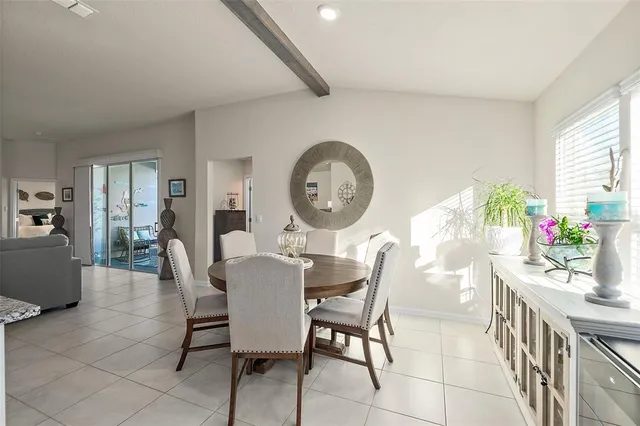 a view of a dining room with furniture and a large window