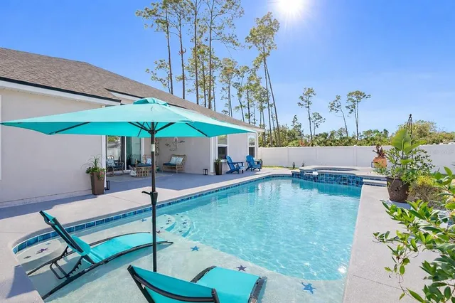 swimming pool view with a seating space