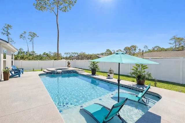 a view of a swimming pool with a lounge chairs