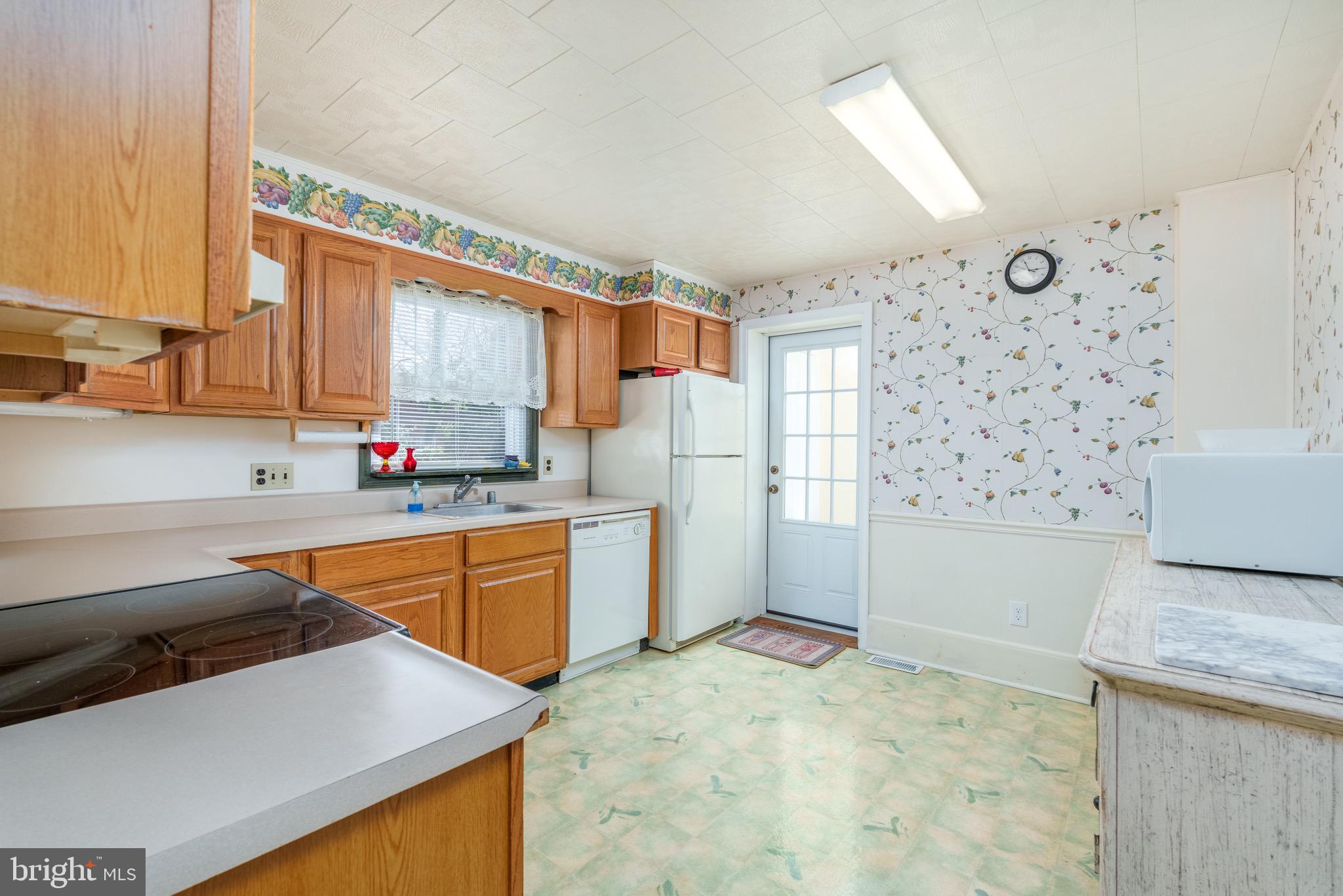 121 Devonshire Road Wilmington, DE 19803 - Photo 15 of 31 a kitchen with granite countertop a sink stainless steel appliances and cabinets