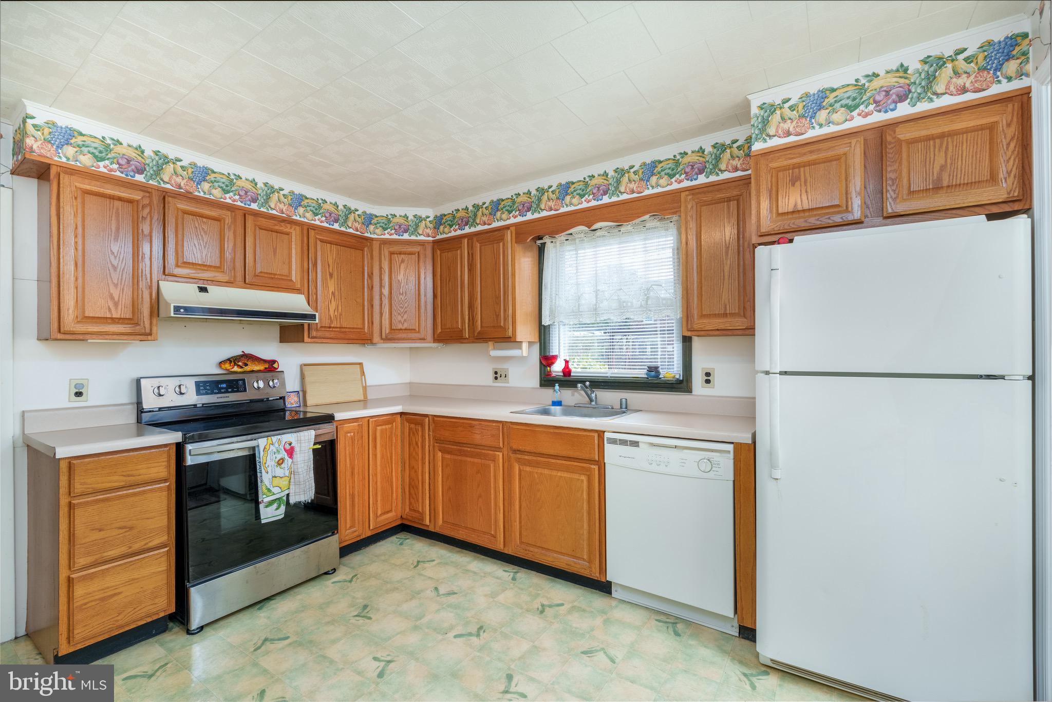 121 Devonshire Road Wilmington, DE 19803 - Photo 16 of 31 a kitchen with stainless steel appliances granite countertop a sink stove and refrigerator