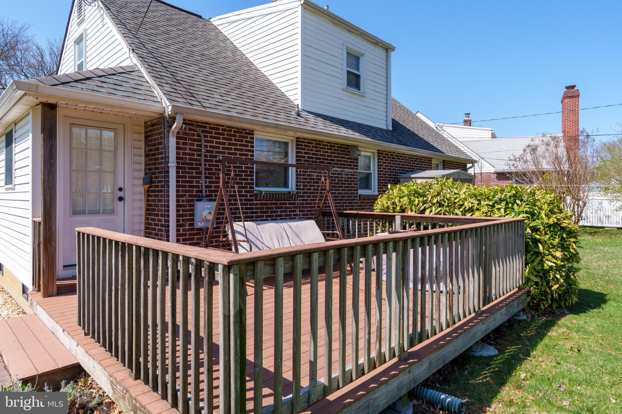 121 Devonshire Road Wilmington, DE 19803 - Photo 6 of 31 a view of a brick house with wooden fence and trees in the background