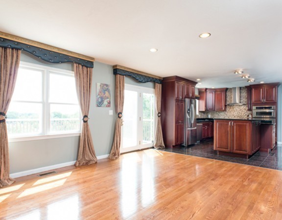 129 Raffaele Drive Waltham, MA 02452 - Photo 13 of 20 a view of a kitchen with refrigerator and wooden floor