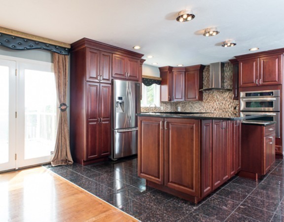 129 Raffaele Drive Waltham, MA 02452 - Photo 14 of 20 a kitchen with stainless steel appliances granite countertop a refrigerator and a sink
